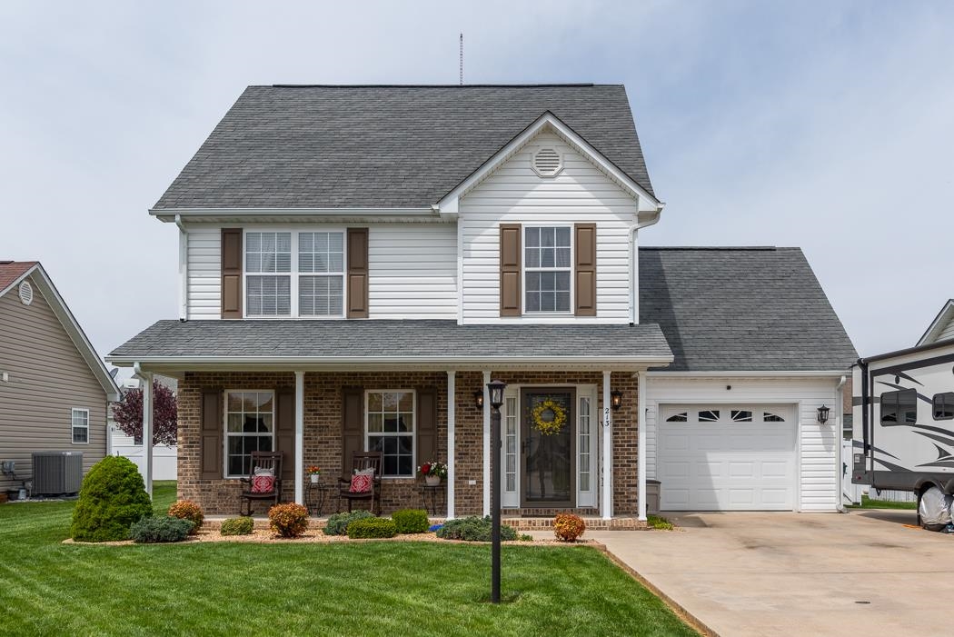 a front view of a house with a yard and porch