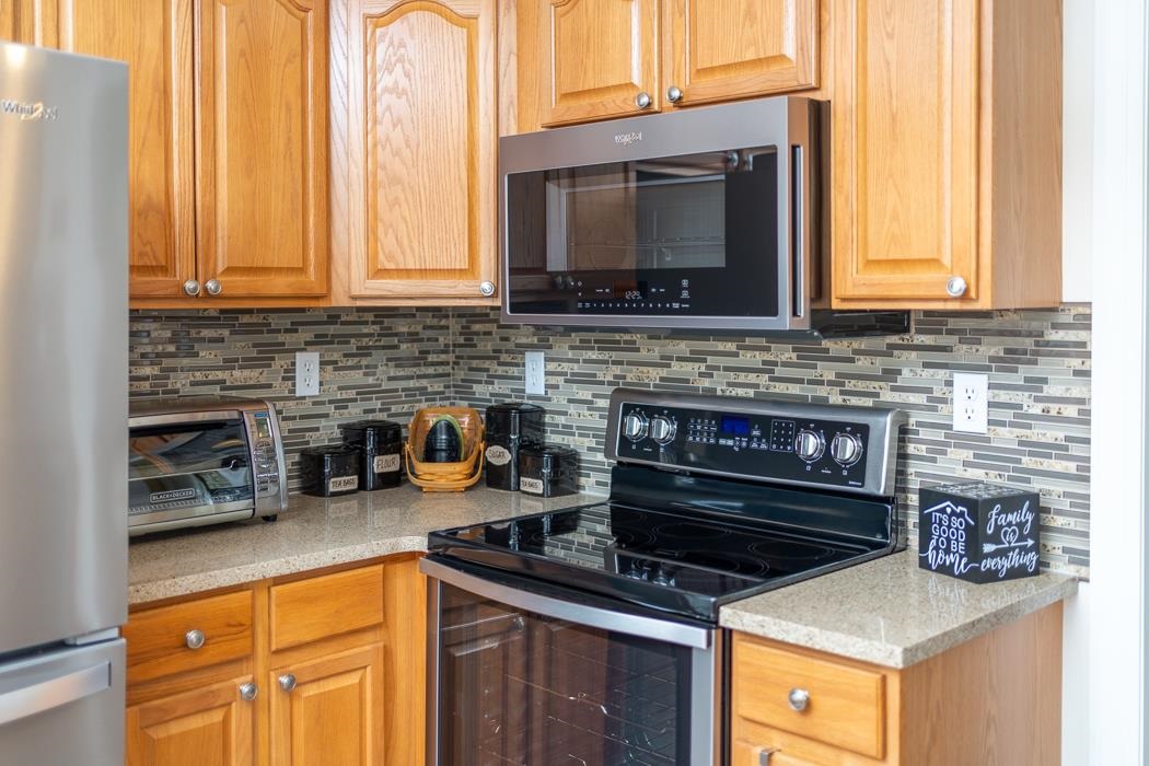213 Inglecress Road Waynesboro, VA 22980 - Photo 14 of 68 a kitchen with stainless steel appliances a stove a microwave and cabinets