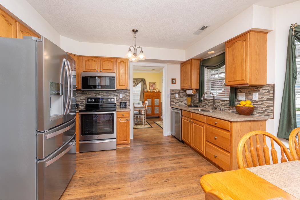213 Inglecress Road Waynesboro, VA 22980 - Photo 19 of 68 a kitchen with stainless steel appliances a refrigerator cabinets and wooden floor