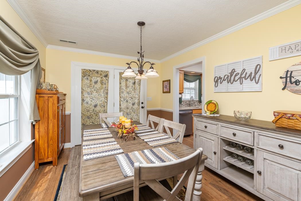 213 Inglecress Road Waynesboro, VA 22980 - Photo 22 of 68 a dining room with furniture a chandelier and wooden floor