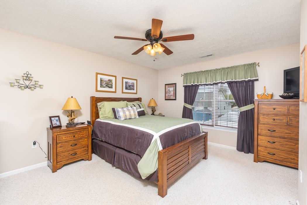 213 Inglecress Road Waynesboro, VA 22980 - Photo 27 of 68 a bedroom with a bed and a chandelier