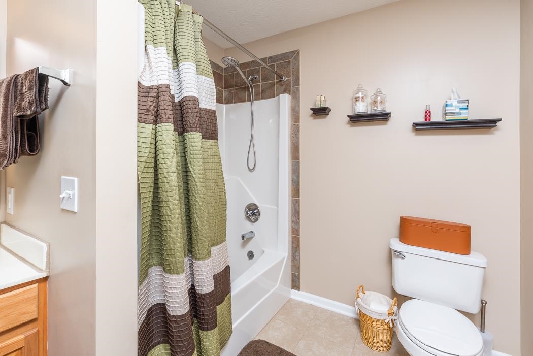 213 Inglecress Road Waynesboro, VA 22980 - Photo 31 of 68 a white toilet sitting next to a bathroom sink and a shower