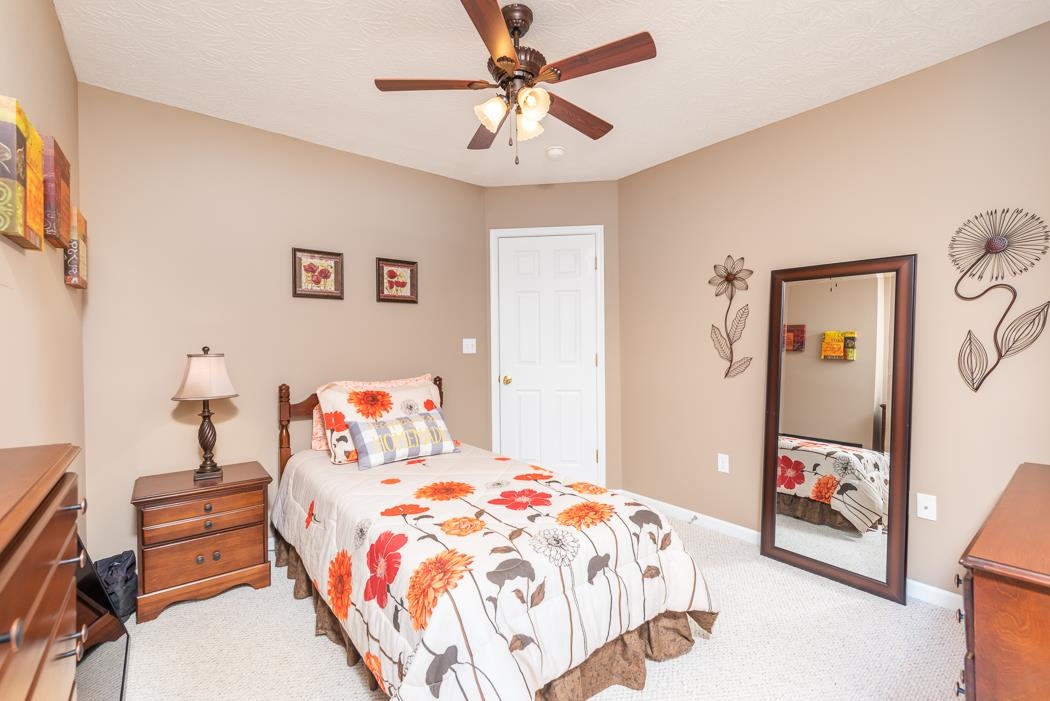 213 Inglecress Road Waynesboro, VA 22980 - Photo 41 of 68 a bedroom with a bed and a chandelier
