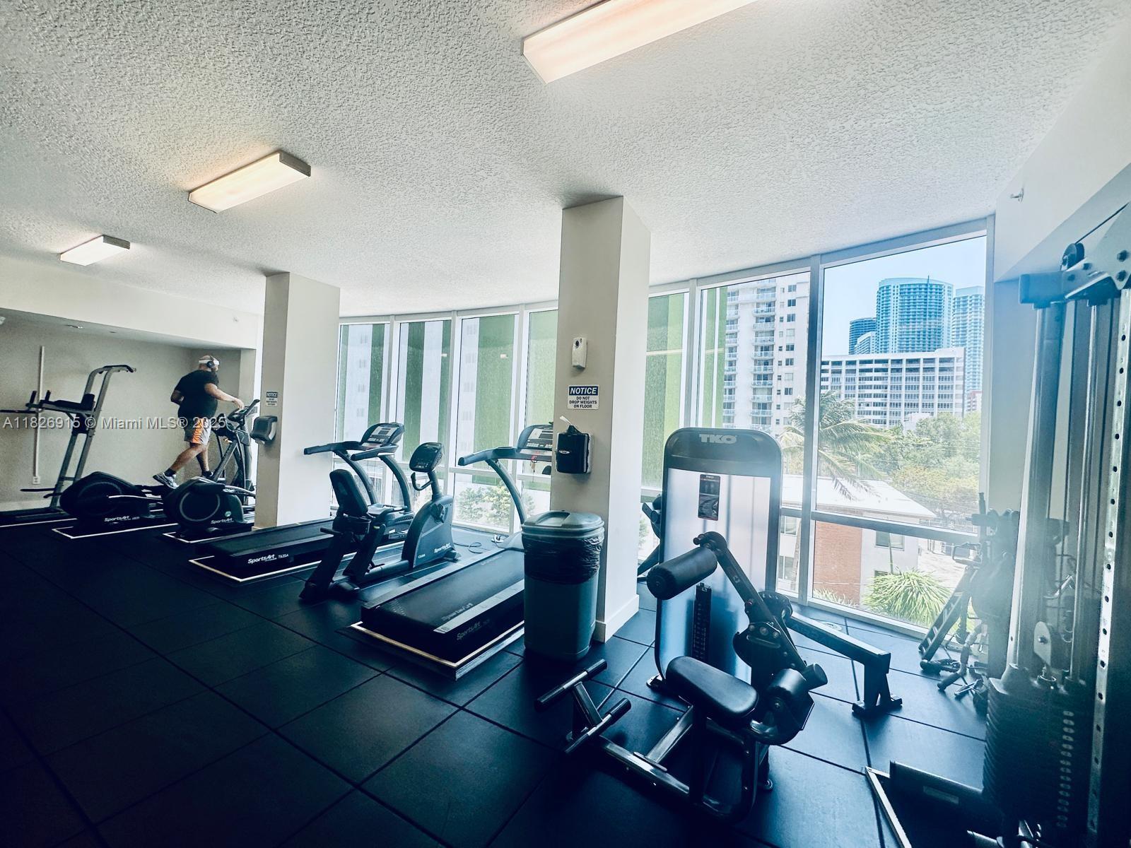 601 Northeast 23rd Street, Unit 1405 Miami, FL 33137 - Photo 20 of 23 a view of a room with gym equipment