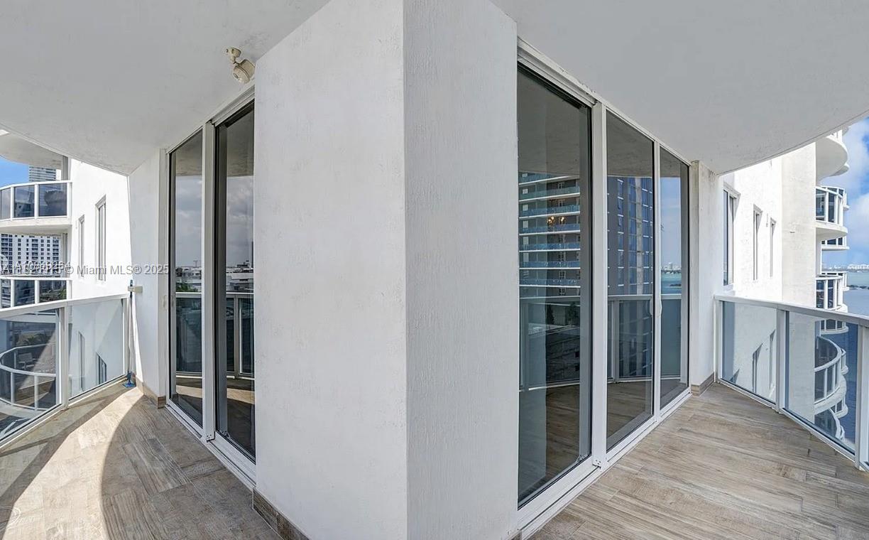 601 Northeast 23rd Street, Unit 1405 Miami, FL 33137 - Photo 2 of 23 a view of hallway with wooden floor and windows