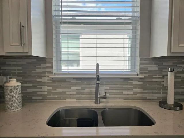 a kitchen with a sink and a window