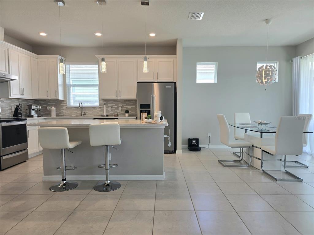1973 Spring Shower Circle Kissimmee, FL 34744 - Photo 12 of 43 a kitchen with a sink a counter top space appliances and cabinets