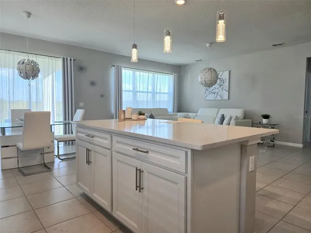 a kitchen with a sink cabinets and a window