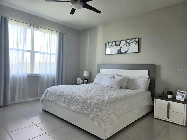 a bedroom with a bed and a window