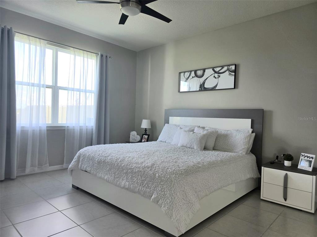 1973 Spring Shower Circle Kissimmee, FL 34744 - Photo 20 of 43 a bedroom with a bed and a window