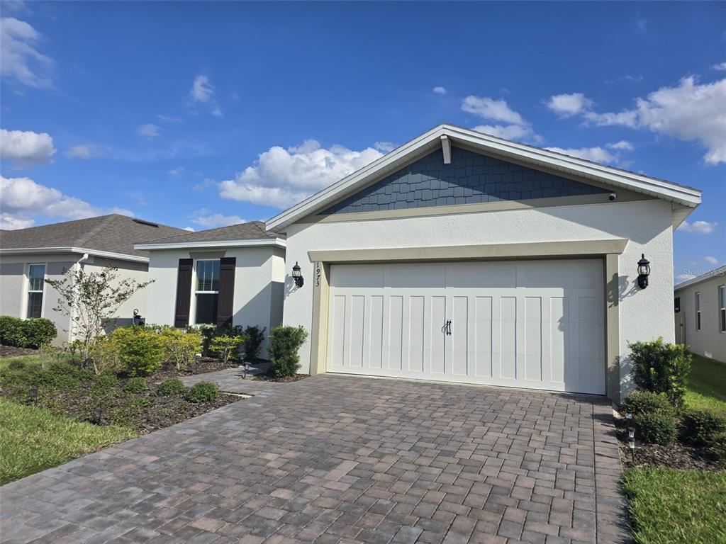 1973 Spring Shower Circle Kissimmee, FL 34744 - Photo 2 of 43 a front view of a house with a yard and garage