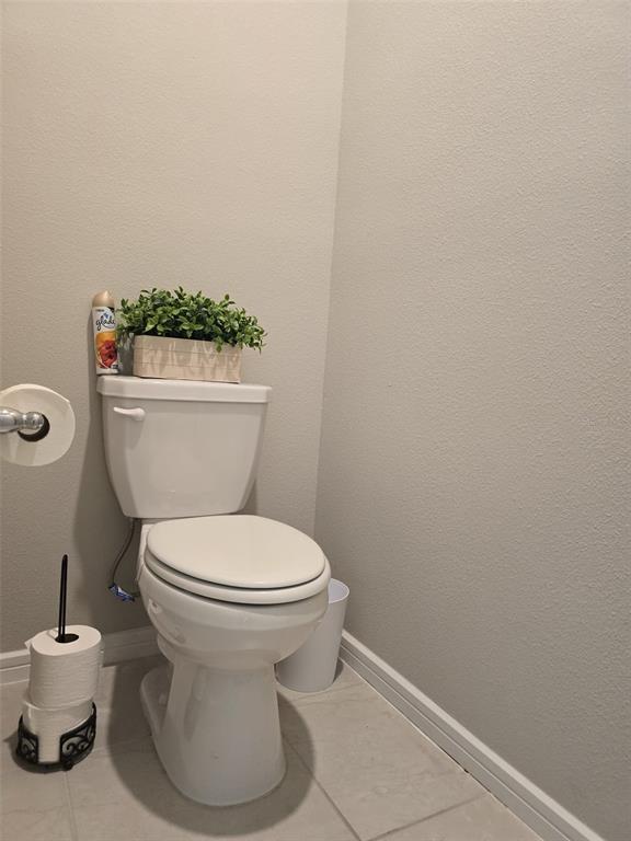 1973 Spring Shower Circle Kissimmee, FL 34744 - Photo 25 of 43 a white toilet sitting next to a white sink and vanity