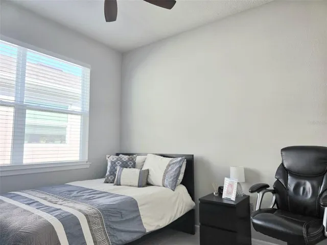 a bedroom with a bed and a chair