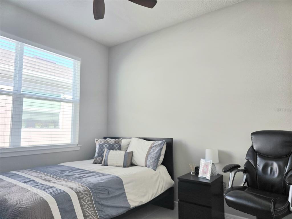 1973 Spring Shower Circle Kissimmee, FL 34744 - Photo 26 of 43 a bedroom with a bed and a chair