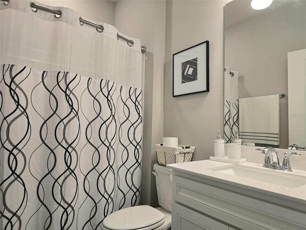 1973 Spring Shower Circle Kissimmee, FL 34744 - Photo 27 of 43 a bathroom with a granite countertop sink and a mirror