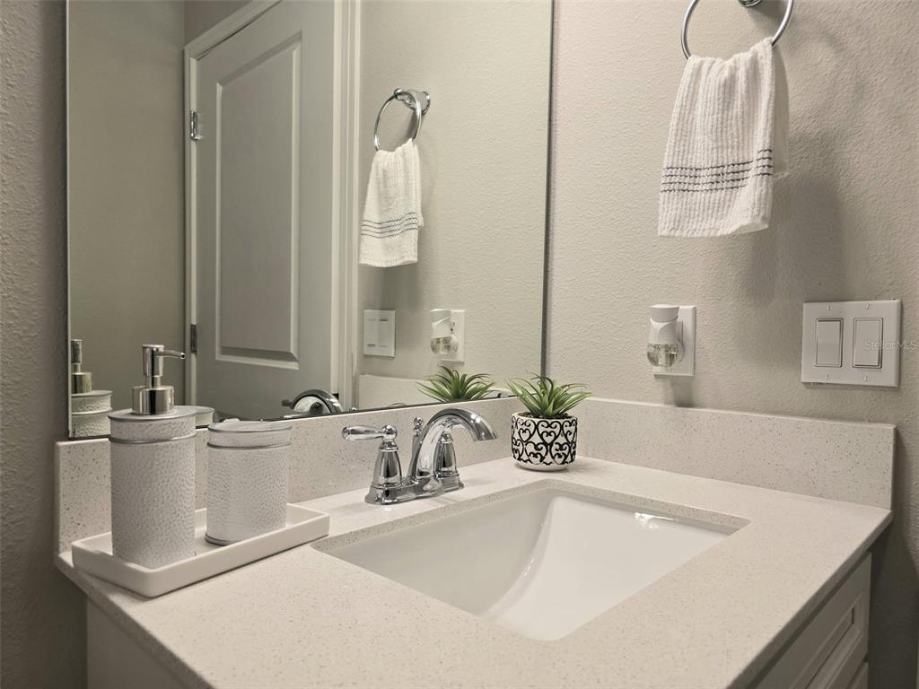 1973 Spring Shower Circle Kissimmee, FL 34744 - Photo 29 of 43 a bathroom with a sink and a mirror