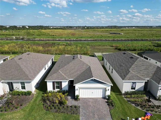 a aerial view of a house with a yard and a garden