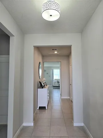 a view of a hallway to a livingroom with furniture
