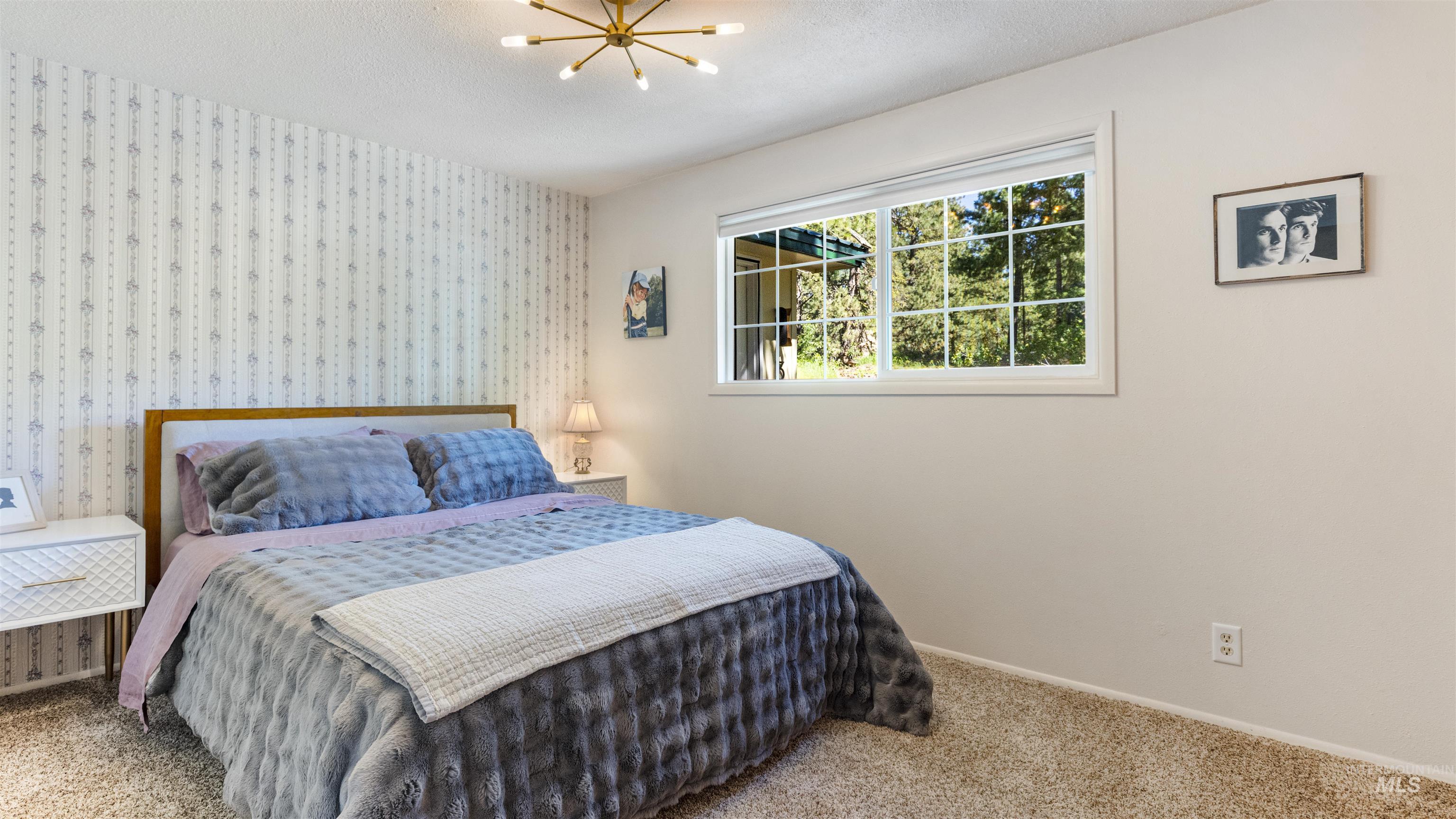 3 Laguna Place Cascade, ID 83611 - Photo 17 of 43 Dining area featuring multiple grid-pattern windows, a paneled door with grid-pattern glass, beadboard wainscoting, and a ceiling-mounted light fixture