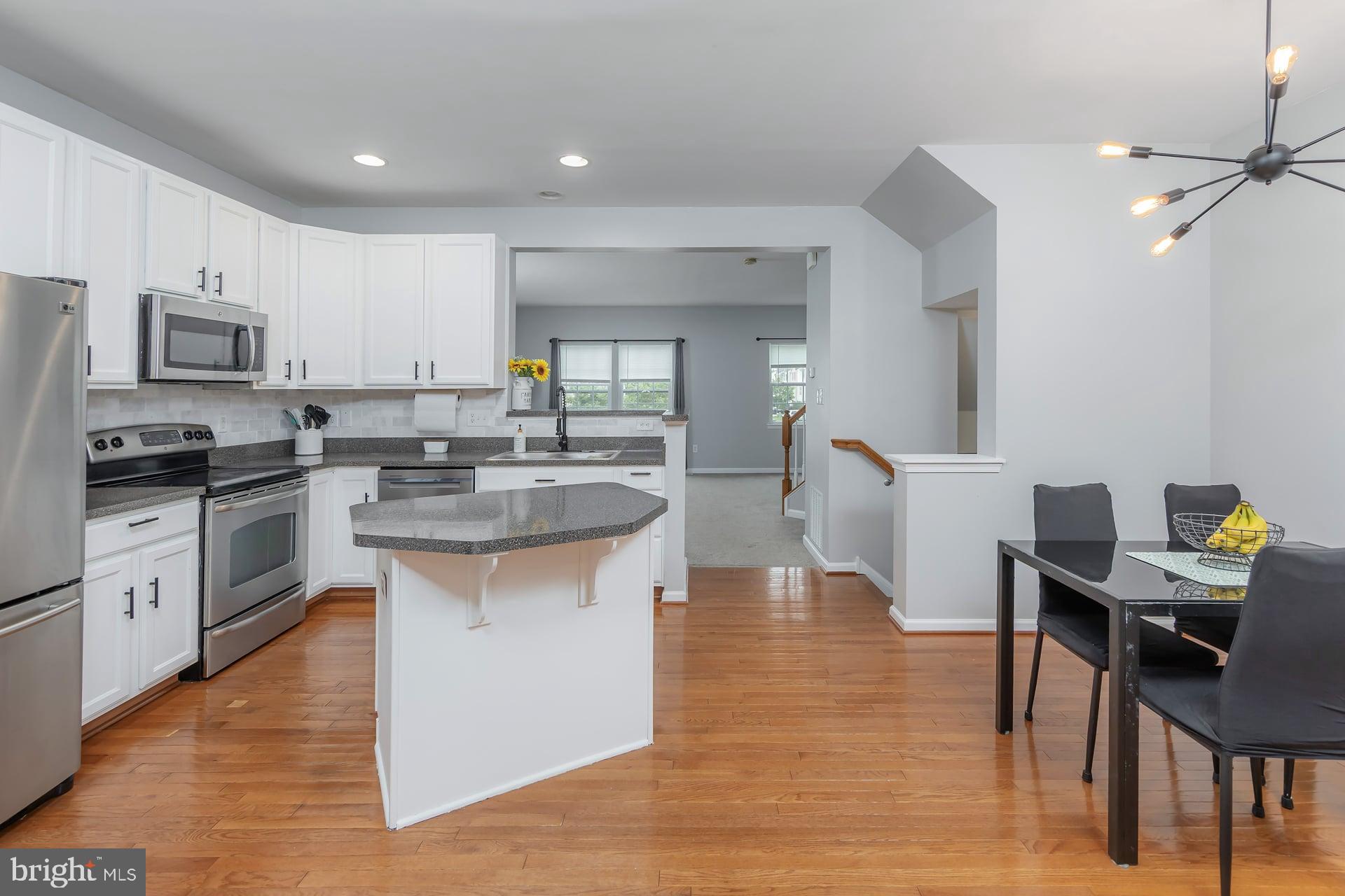 372 Concetta Drive Mount Royal, NJ 08061 - Photo 5 of 25 a kitchen with stainless steel appliances granite countertop a stove top oven a sink a dining table and chairs
