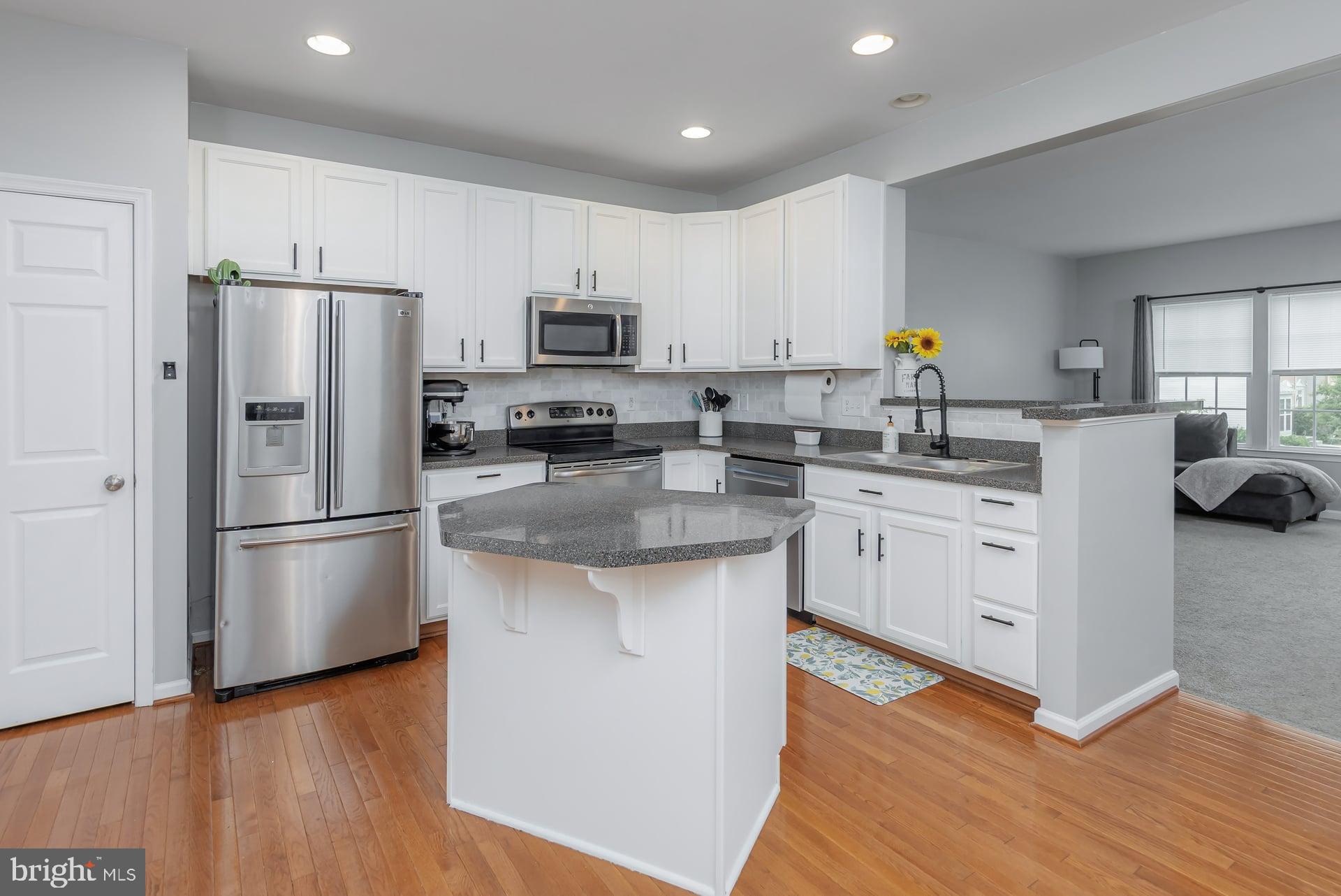 372 Concetta Drive Mount Royal, NJ 08061 - Photo 6 of 25 a kitchen with white cabinets and stainless steel appliances