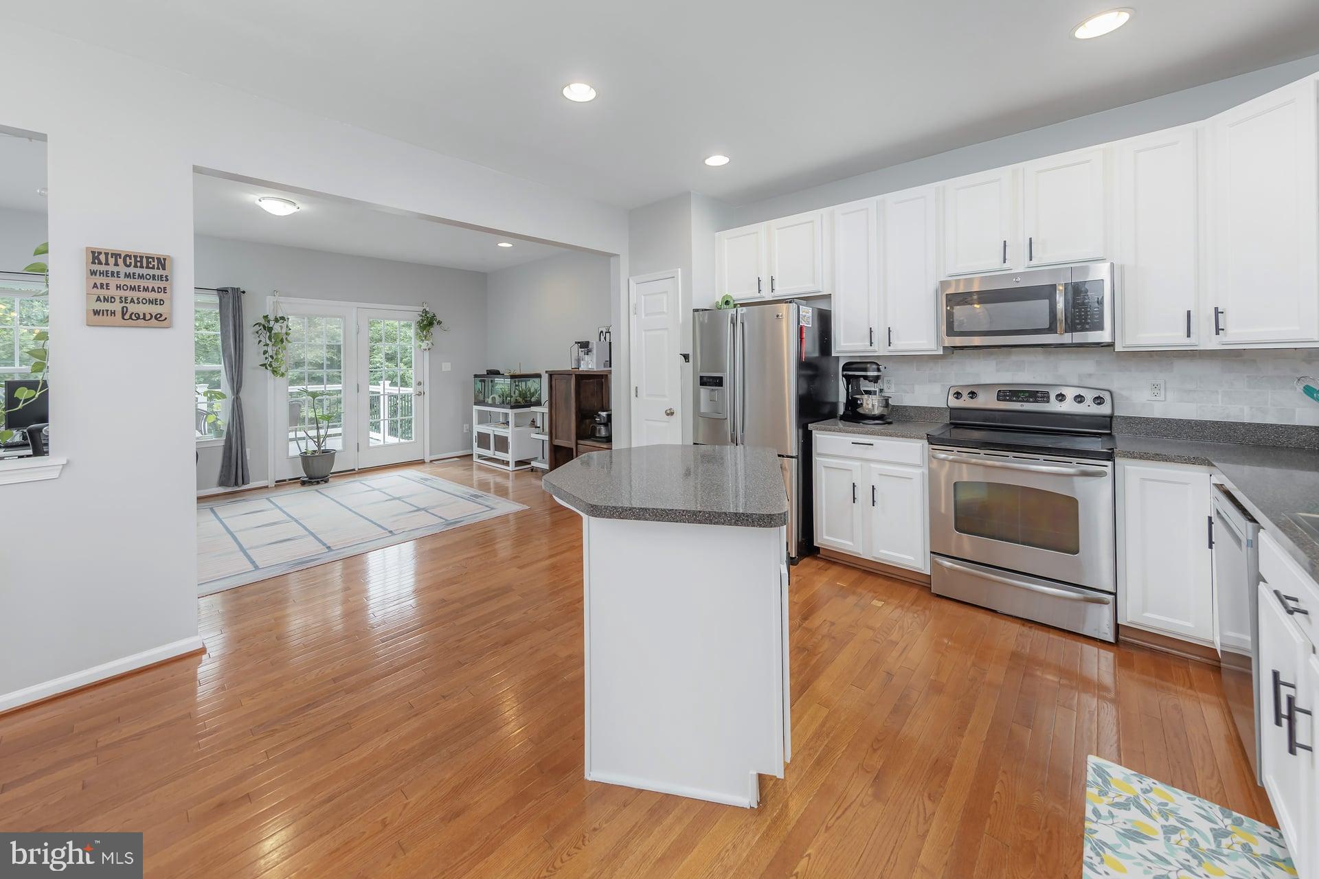 372 Concetta Drive Mount Royal, NJ 08061 - Photo 10 of 25 a large kitchen with stainless steel appliances granite countertop a stove top oven a refrigerator a sink and dishwasher with wooden floor