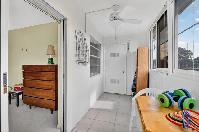 a view of a patio with table and chairs potted plants