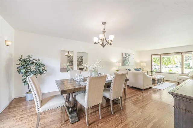 a view of a dining room with furniture and chandelier