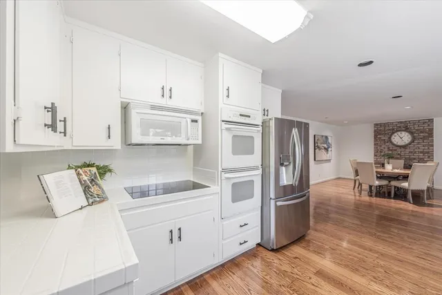 a kitchen with granite countertop a refrigerator and a sink