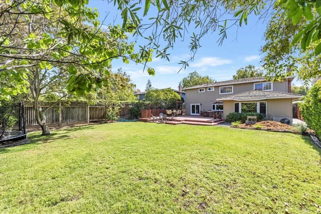 a view of a house with pool and sitting area