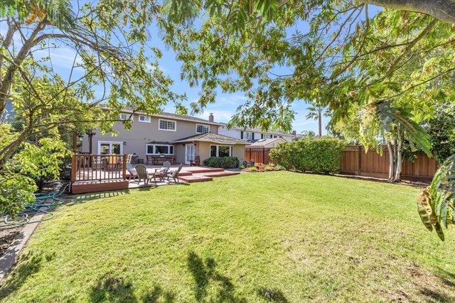 a view of a house with swimming pool and sitting area