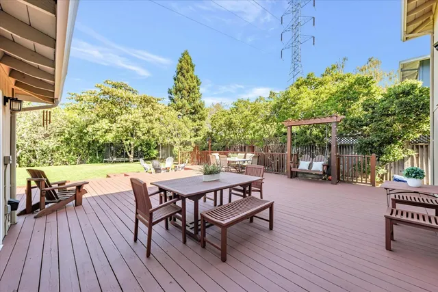 a view of a chairs and table on the wooden deck