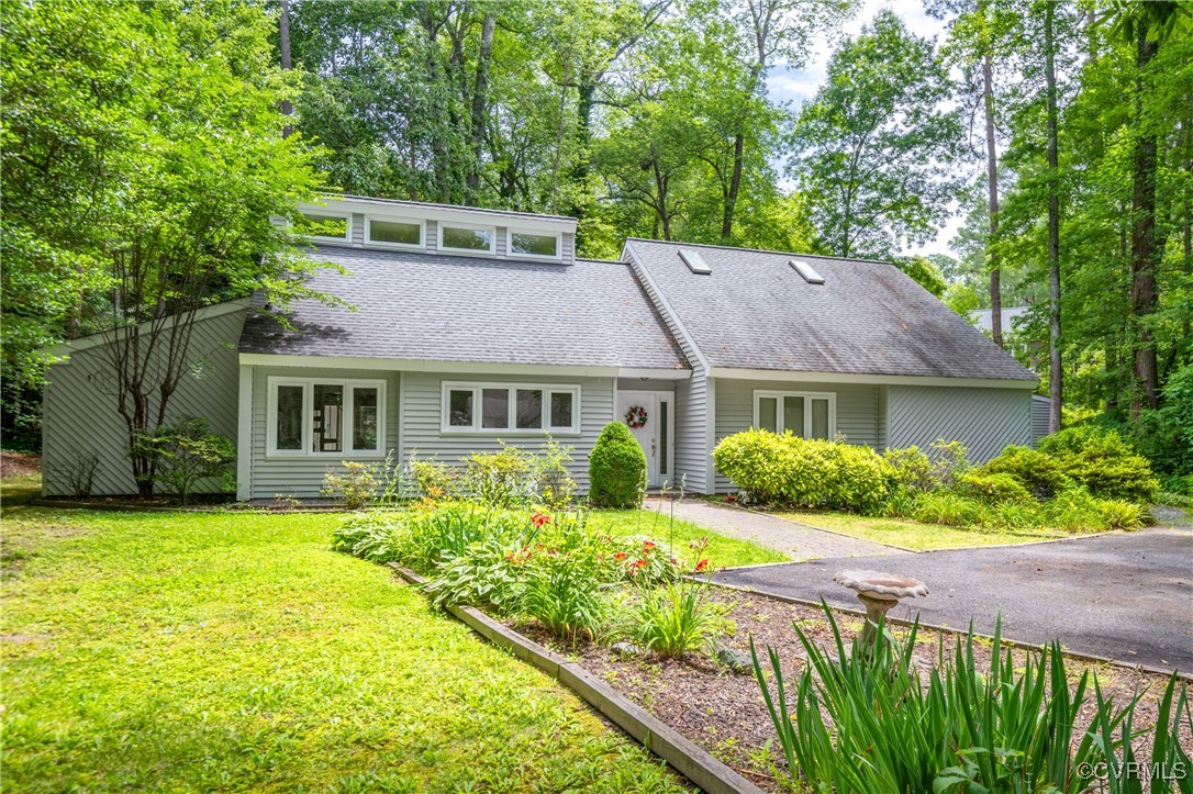 a front view of house with yard and green space