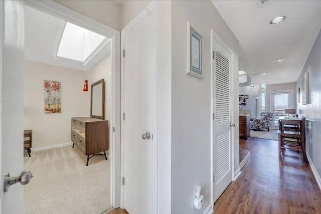 a view of a hallway with workspace and a window