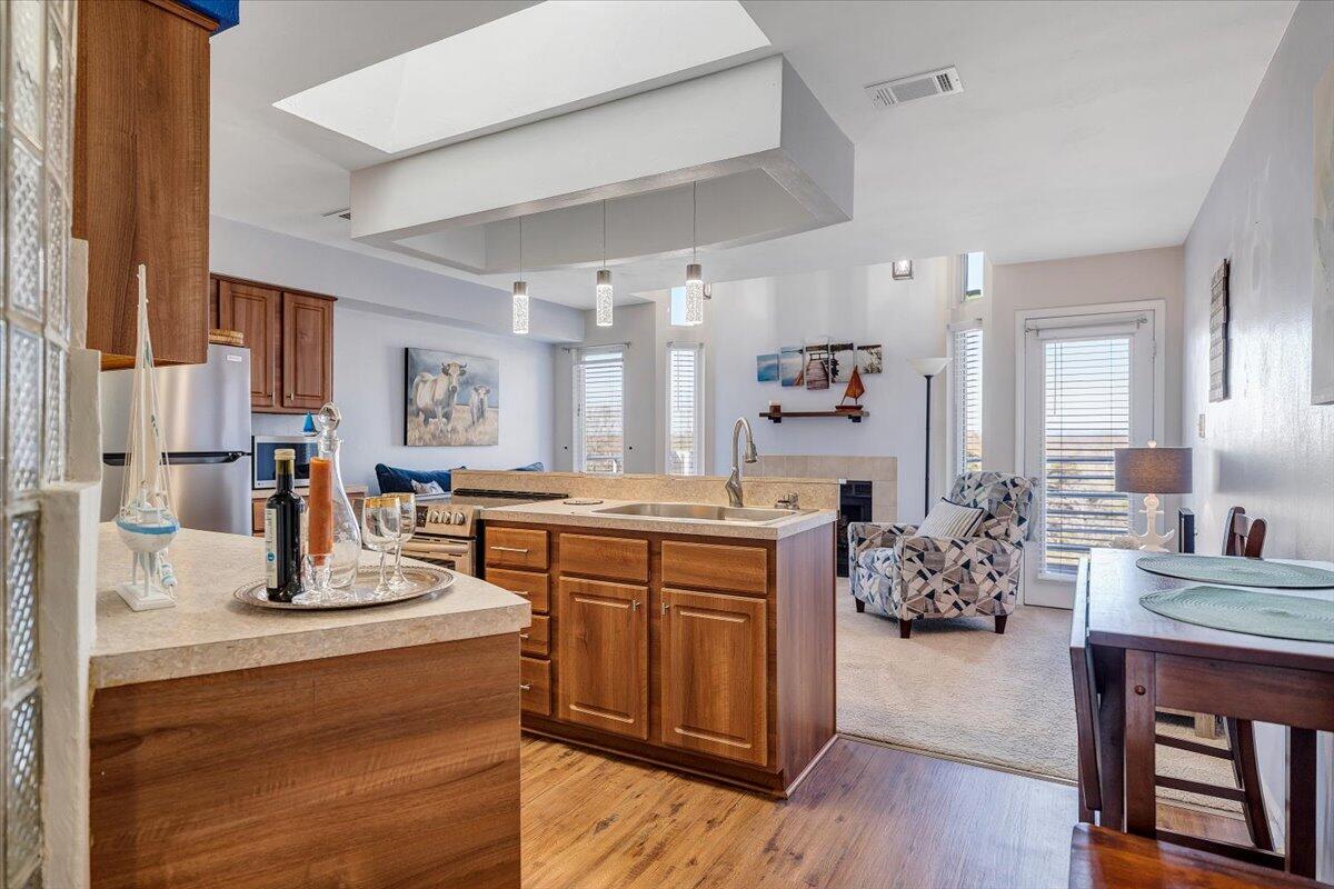 71 Waterside Circle, Unit D6 Moneta, VA 24121 - Photo 12 of 52 a kitchen with kitchen island granite countertop a sink cabinets and wooden floor