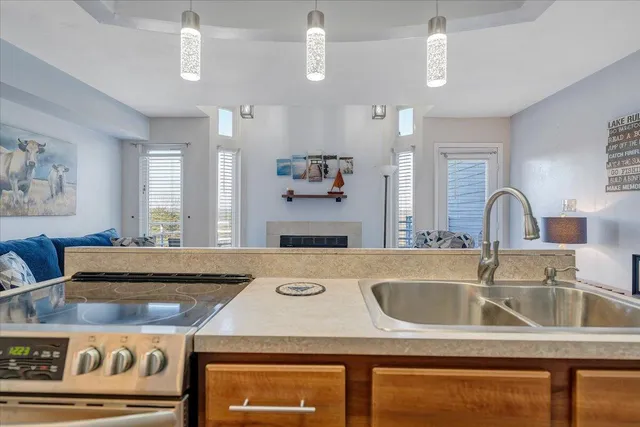 a kitchen with a sink a stove and a refrigerator