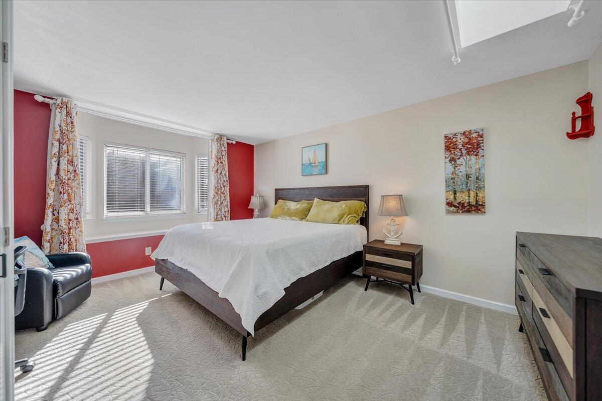 71 Waterside Circle, Unit D6 Moneta, VA 24121 - Photo 16 of 52 a bedroom with a bed wooden floor and a table