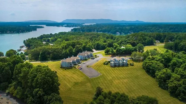 an aerial view of a house with a lake view