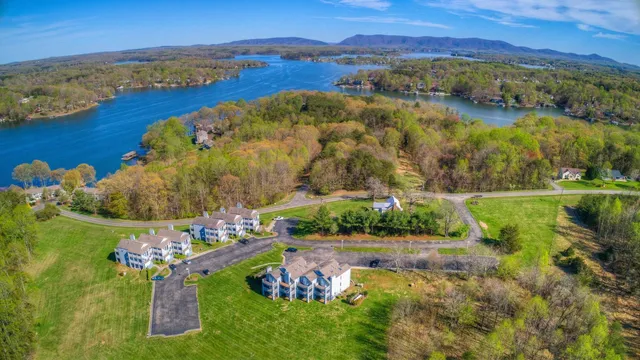 a roof deck with table and chairs under an umbrella