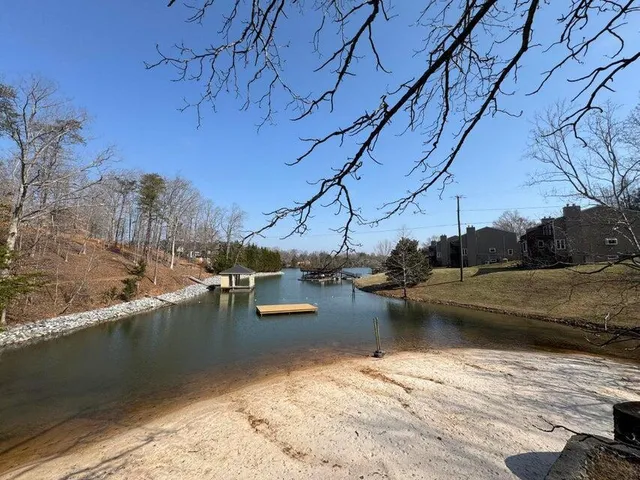 a front view of residential houses with yard and mountain view in back