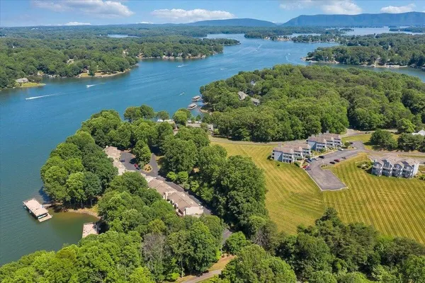 an aerial view of residential house with outdoor space and lake view