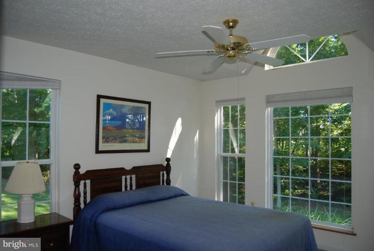 7218 Clyde Jones Road Owings, MD 20736 - Photo 5 of 9 a bedroom with a bed and a table