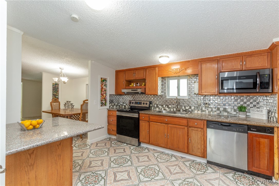 2924 Whitehouse Road Colonial Heights, VA 23834 - Photo 16 of 50 a kitchen with stainless steel appliances granite countertop a stove a sink and a microwave
