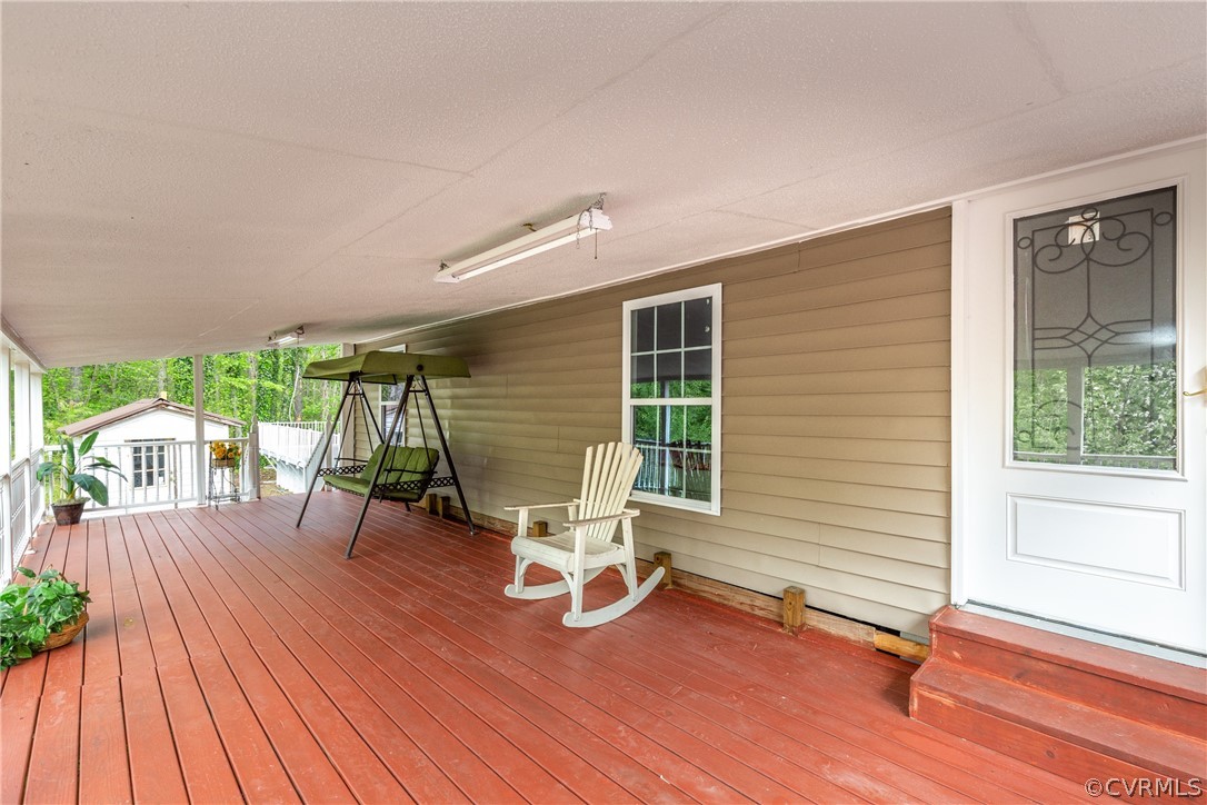 2924 Whitehouse Road Colonial Heights, VA 23834 - Photo 8 of 50 a view of a patio with table and chairs with wooden floor and fence