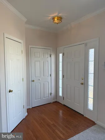 a view of a livingroom with wooden floor and closet area
