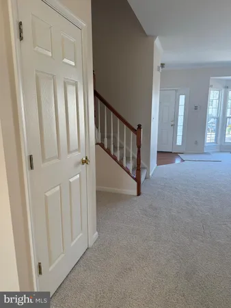 a view of a hallway with entryway door