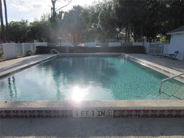 a view of a field with trees in the background
