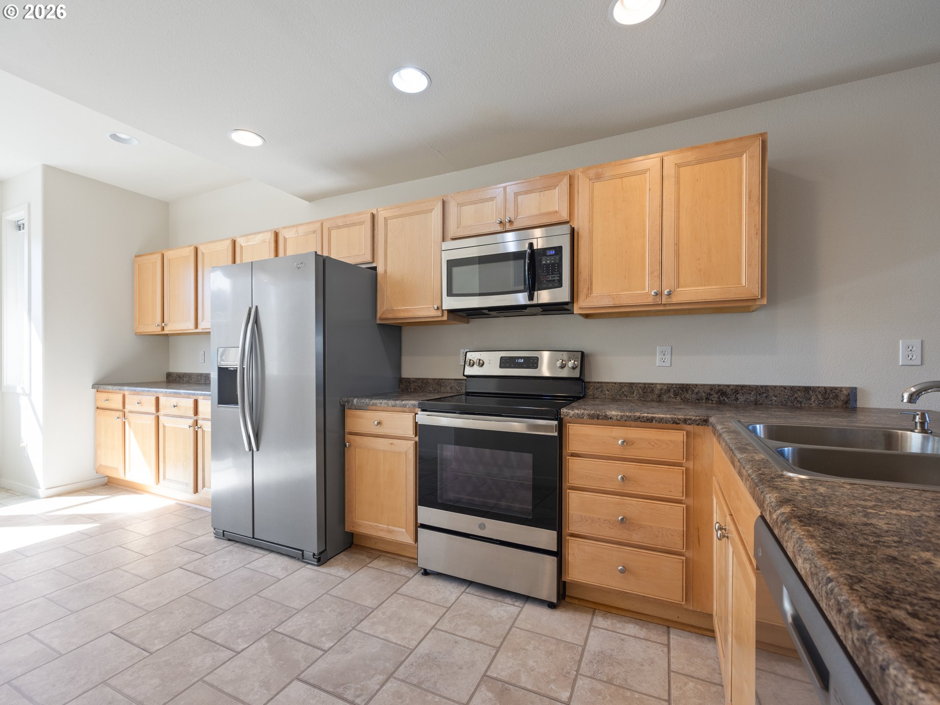 475 Southeast 35th Street, Unit C15 Newport, OR 97366 - Photo 11 of 41 a kitchen with stainless steel appliances granite countertop a refrigerator stove and sink