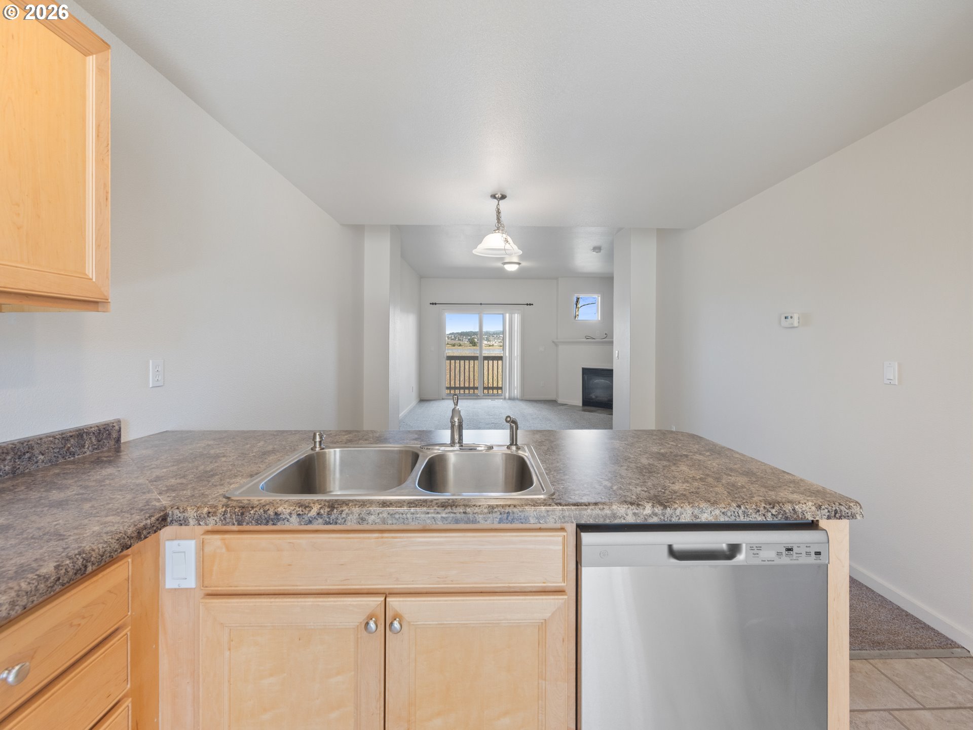 475 Southeast 35th Street, Unit C15 Newport, OR 97366 - Photo 13 of 41 a kitchen with granite countertop a sink a counter top space and cabinets
