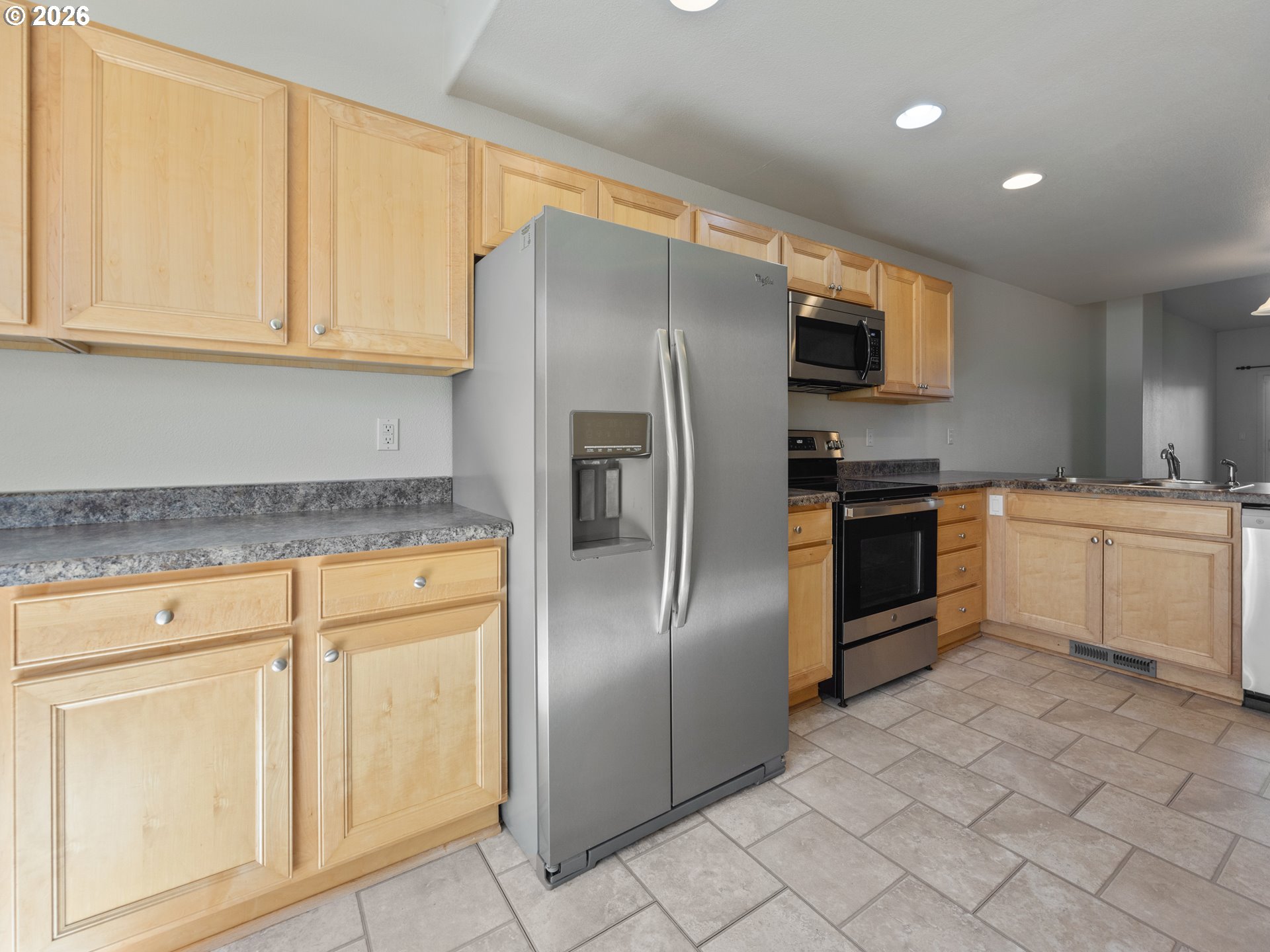 475 Southeast 35th Street, Unit C15 Newport, OR 97366 - Photo 14 of 41 a kitchen with white cabinets stainless steel appliances and sink
